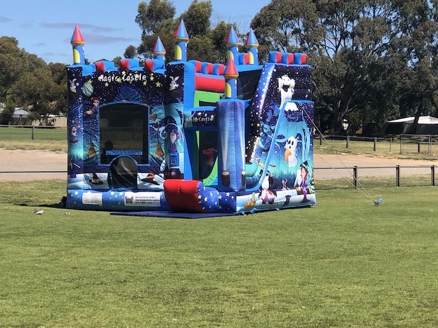 Colourful Magical Jumping Castle for hire Adelaide - wizard jumping castle in the park side view